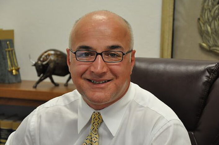 Man smiling in an office setting